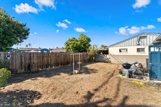 a backyard of a house with table and chairs