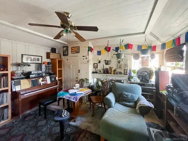 a living room with furniture a flat screen tv and a bookshelf