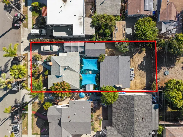 an aerial view of a houses with yard