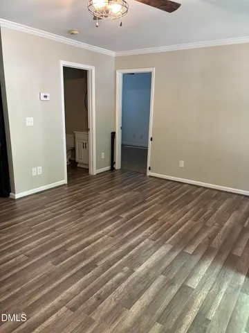 an empty room with wooden floor and closet