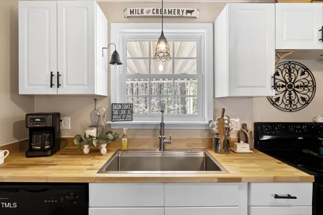 a kitchen with kitchen island a counter top space cabinets and a sink
