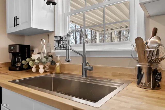 a kitchen with a sink a counter and cabinets