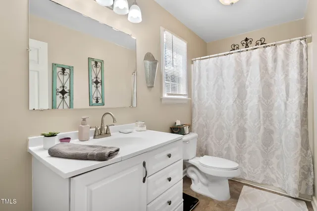 a bathroom with a sink toilet and mirror