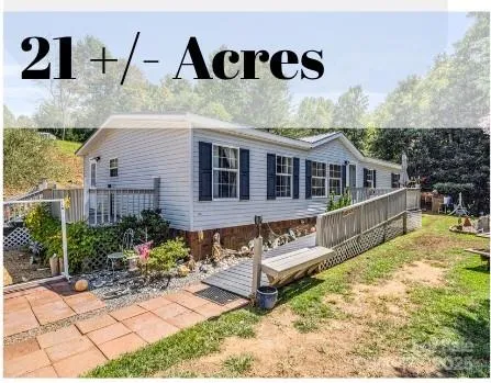 a view of a house with pool and sitting area