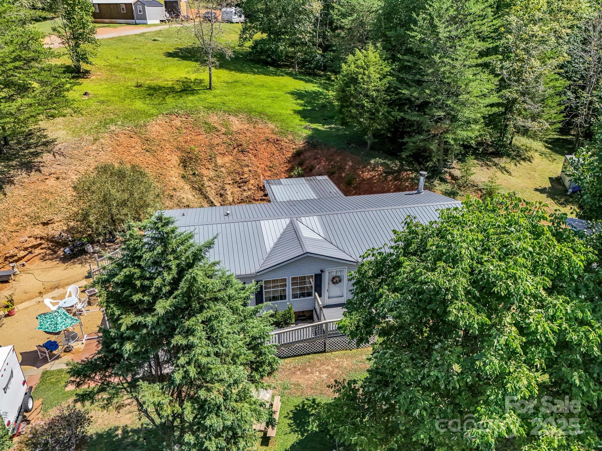 282 Reagan Lane Bostic, NC 28018 - Photo 24 of 34 a aerial view of a house with a garden and trees