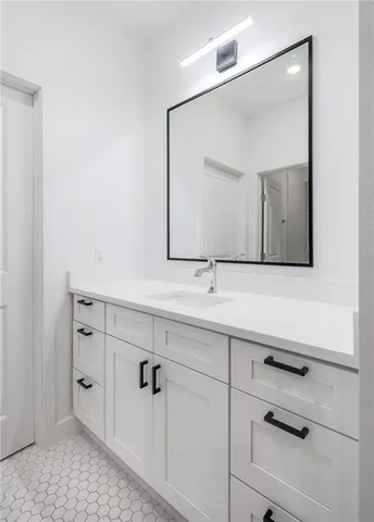 a bathroom with a double vanity sink and mirror