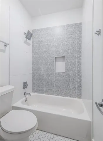 a bathroom with a bathtub and a toilet