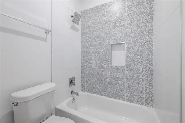 a bathroom with a bathtub and a toilet