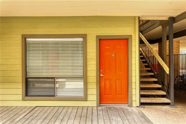 a view of a livingroom with stairs and furniture