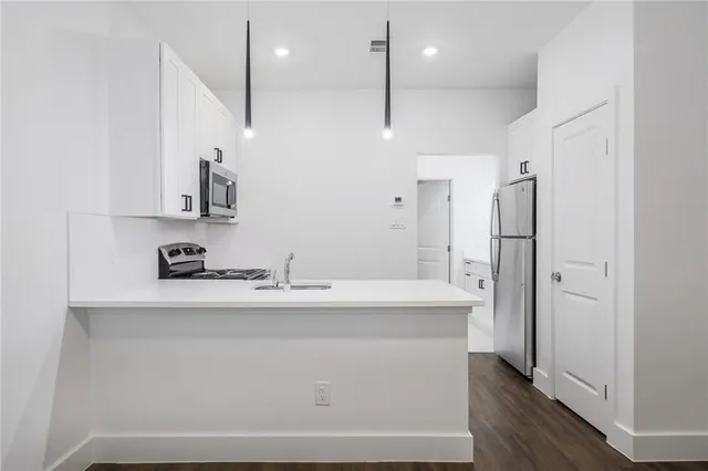 a kitchen with stainless steel appliances a refrigerator and a sink