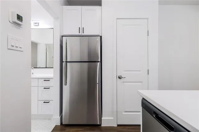 a white refrigerator freezer and a stove sitting inside of a kitchen