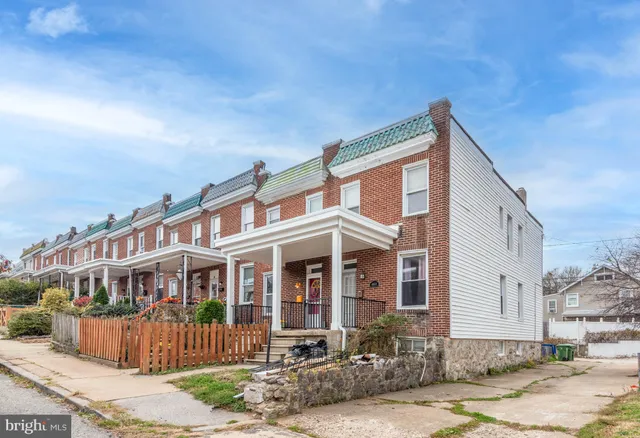 a view of a blue house with large windows