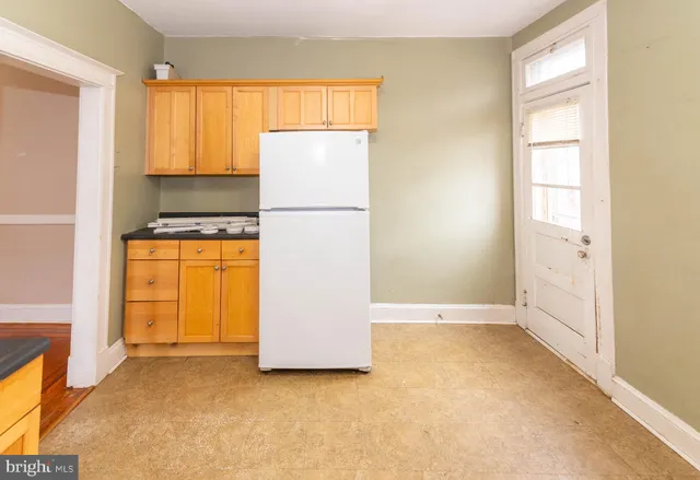 a kitchen with stainless steel appliances a stove a sink and white cabinets