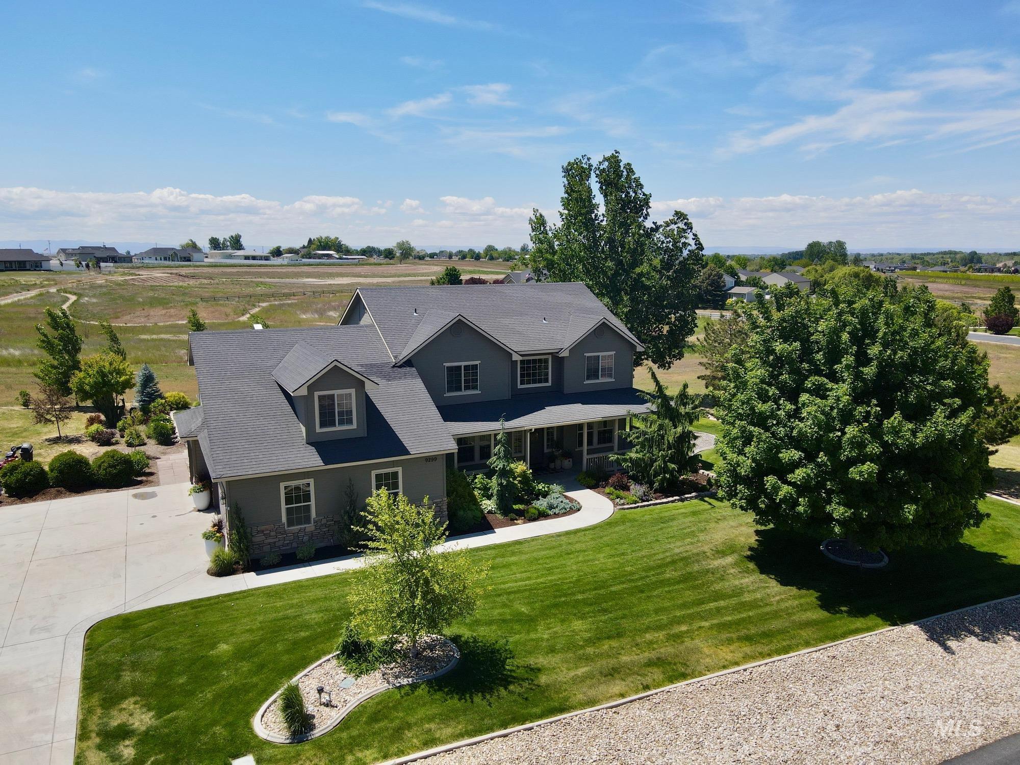 9299 Kemp Road Middleton, ID 83644 - Photo 46 of 50 Two-story residence featuring a gray exterior with stone accents and multiple dormer windows