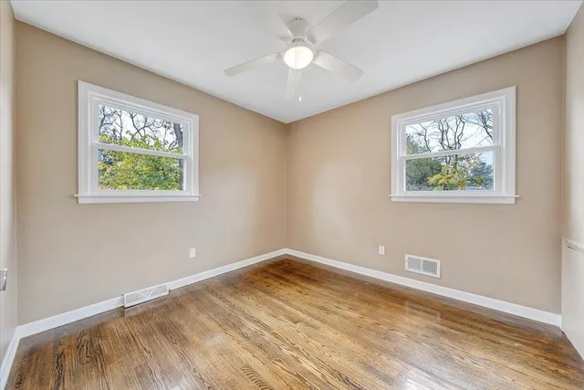 a view of room with window and ceiling fan