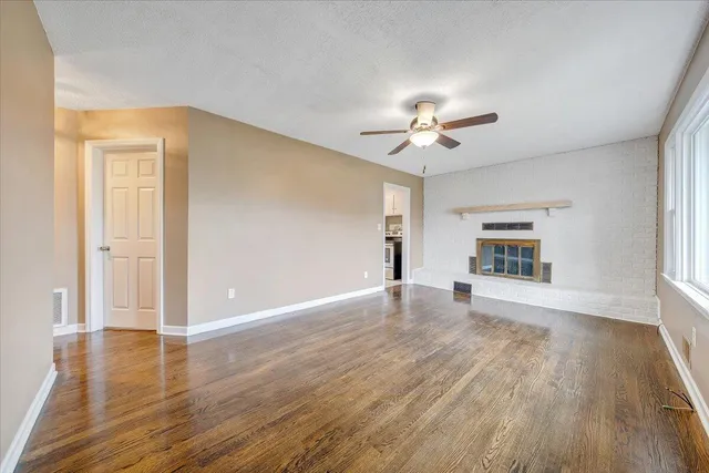 wooden floor in an empty room with a window