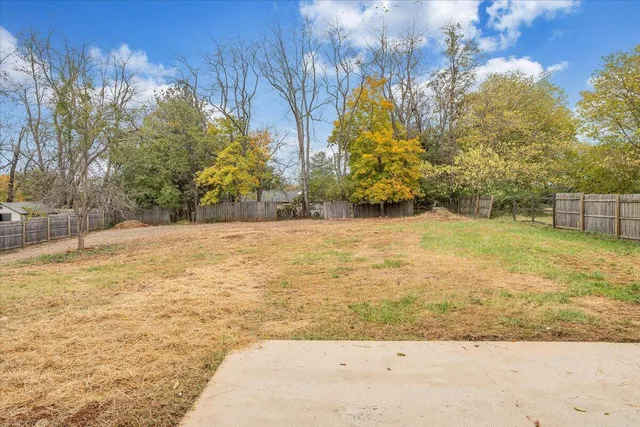 a view of yard with large trees