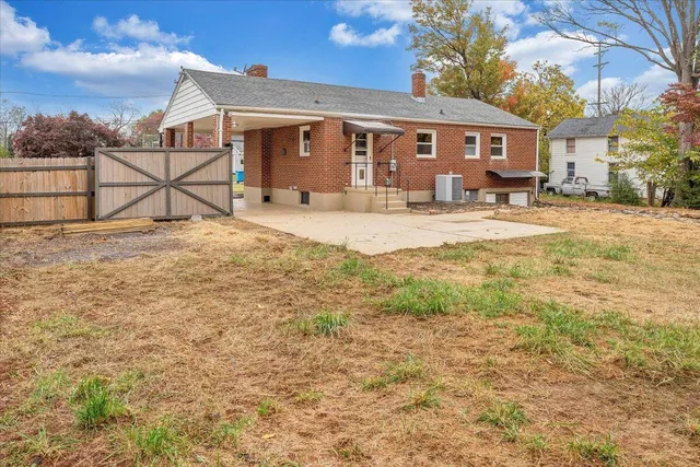 a view of a white house with a yard covered in snow