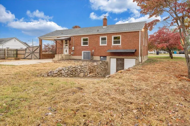 a view of house with yard and trees in front of it