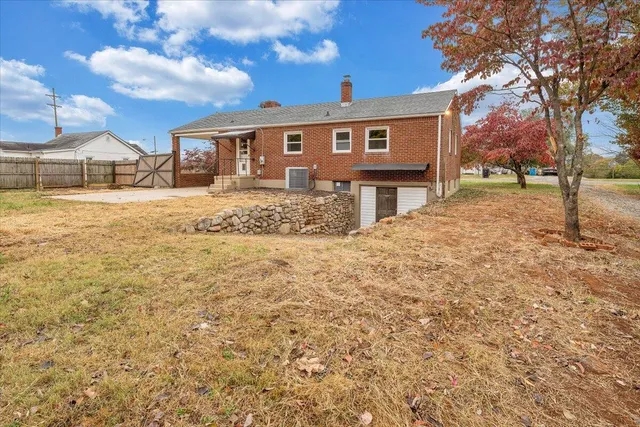 a view of a house with a yard and tree s