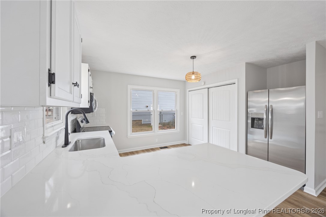 610 Duncan Road Spring Lake, NC 28390 - Photo 13 of 34 a room with a bed a table and chair