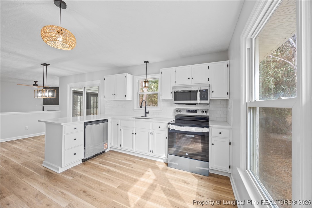 610 Duncan Road Spring Lake, NC 28390 - Photo 14 of 34 a kitchen with stainless steel appliances a stove sink and refrigerator