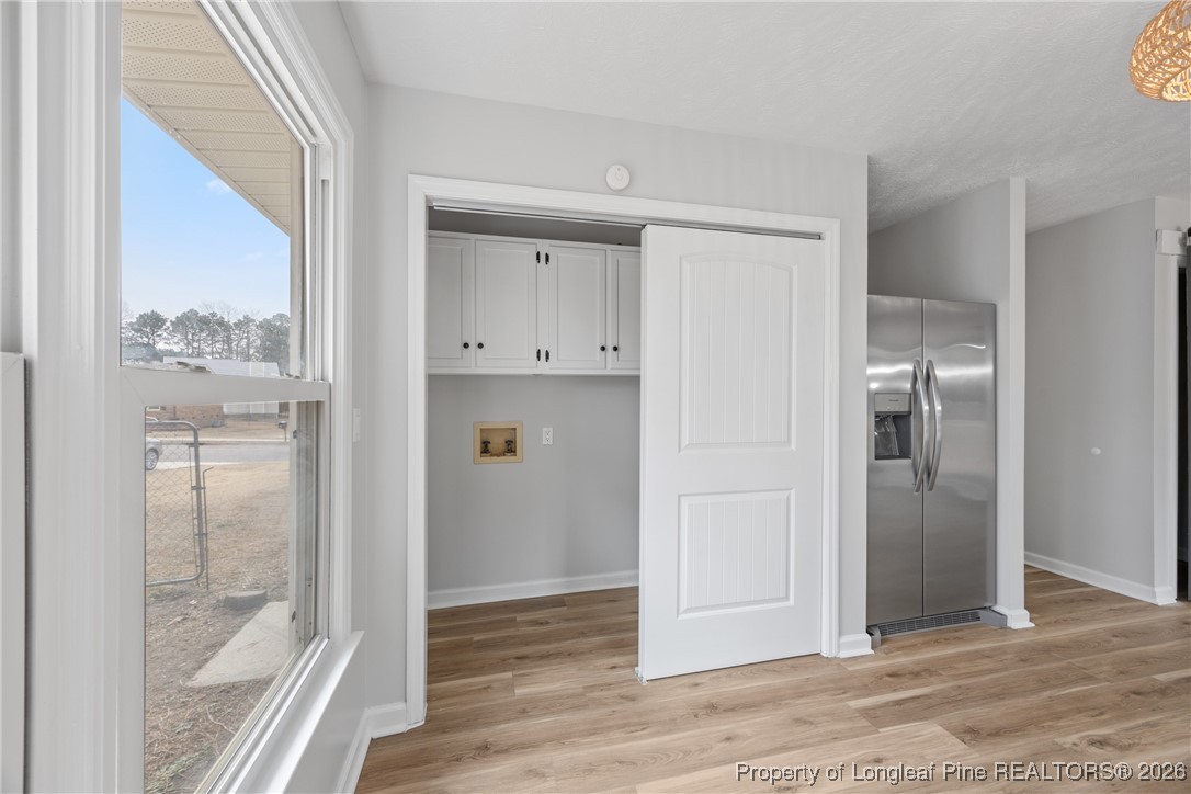 610 Duncan Road Spring Lake, NC 28390 - Photo 16 of 34 a view of a hallway with wooden floor and a bathroom