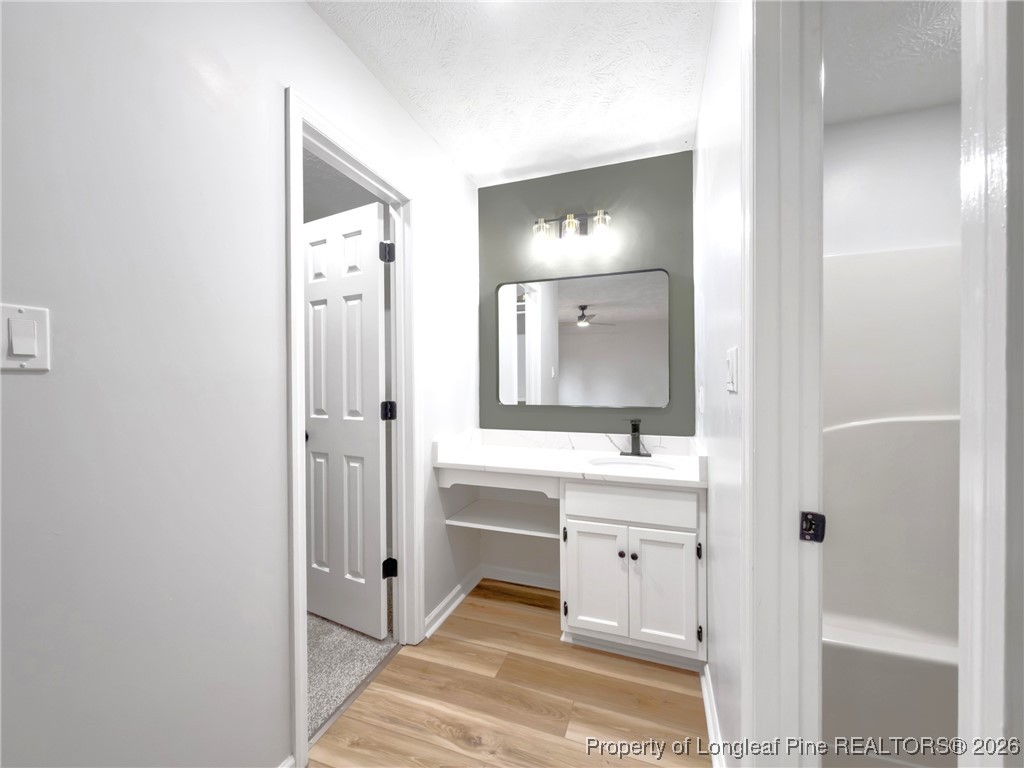 610 Duncan Road Spring Lake, NC 28390 - Photo 21 of 34 a spacious bathroom with a double vanity sink and mirror