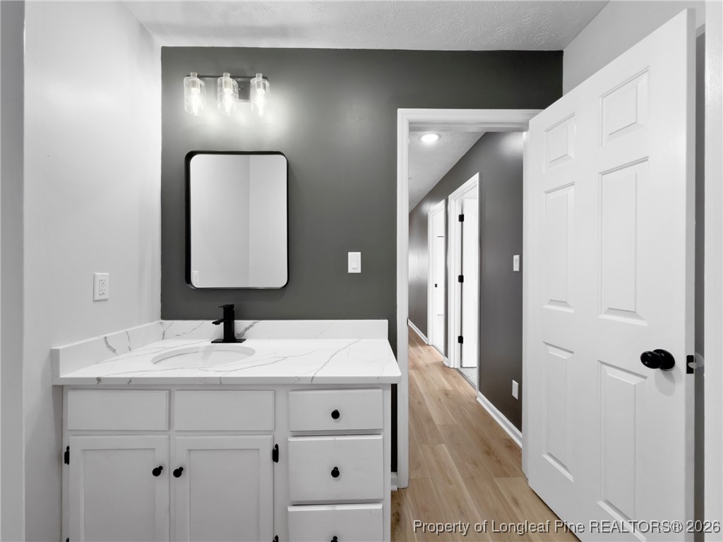 610 Duncan Road Spring Lake, NC 28390 - Photo 26 of 34 a en suite bathroom with a double vanity sink and mirror