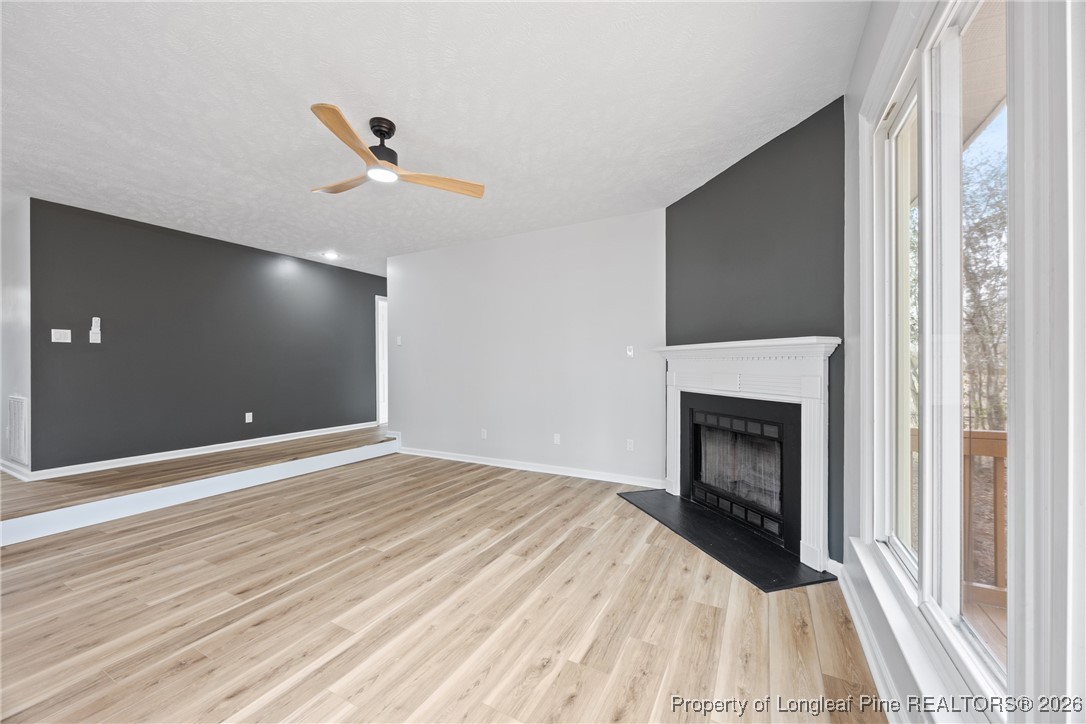 610 Duncan Road Spring Lake, NC 28390 - Photo 9 of 34 a view of empty room with wooden floor and fireplace