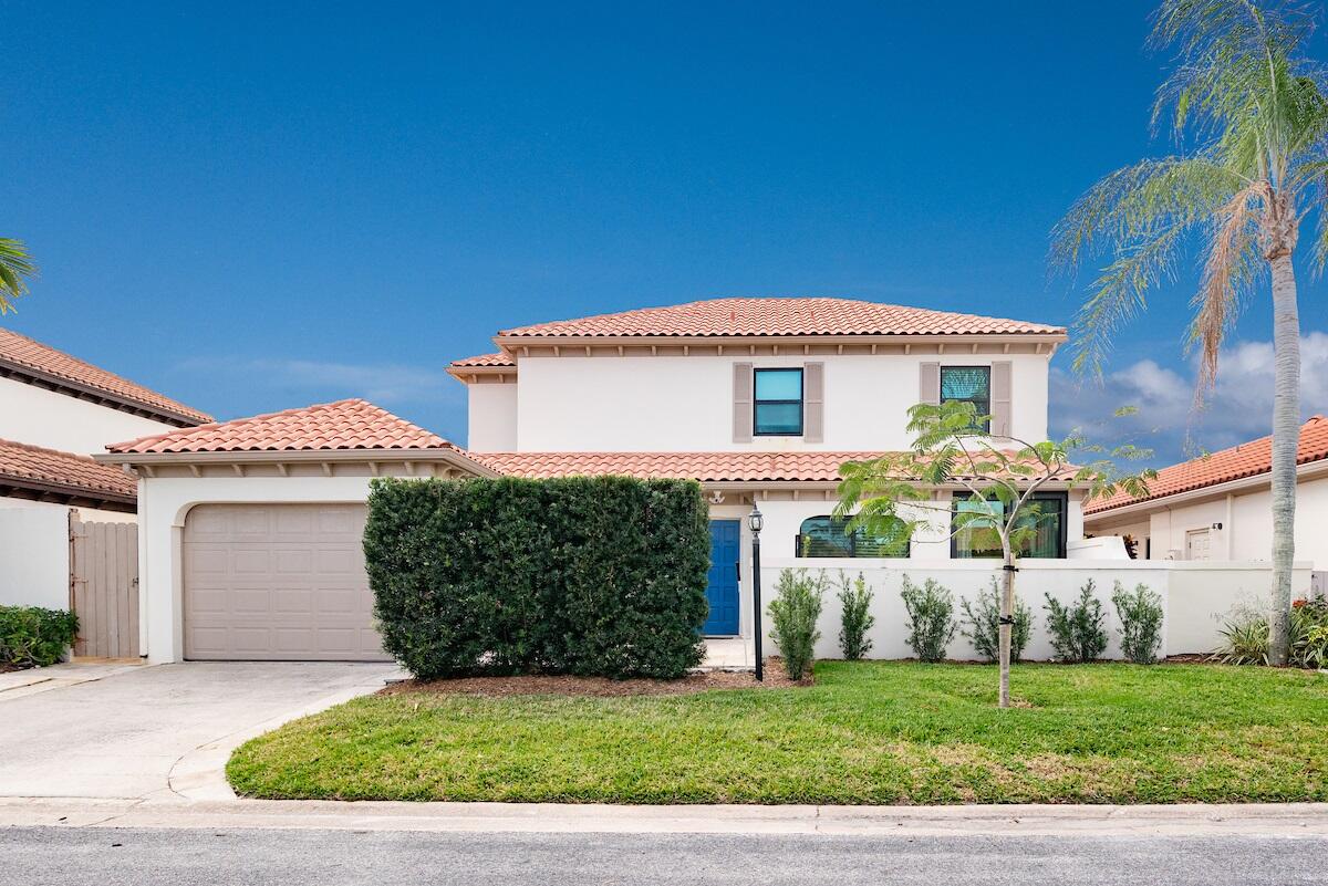 a front view of a house with a garden