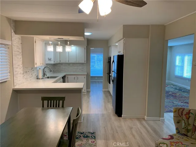 a kitchen with a refrigerator and a sink