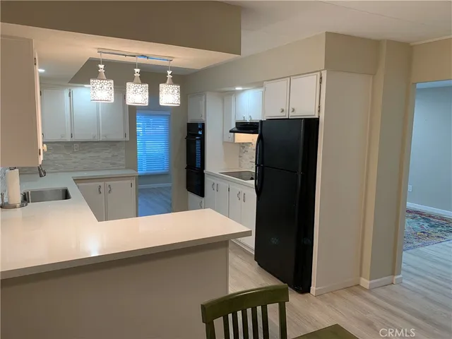 a living room with furniture and chandelier