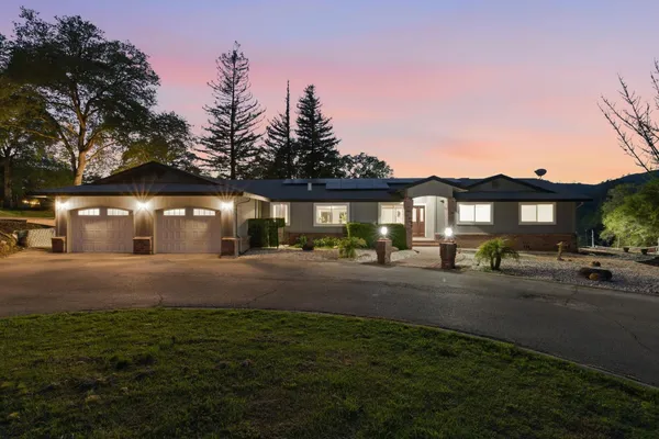a front view of a house with a yard and street view