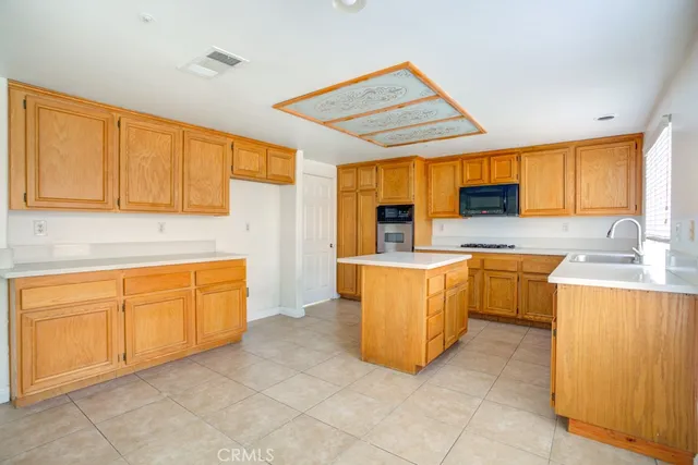 a kitchen with cabinets a sink and appliances