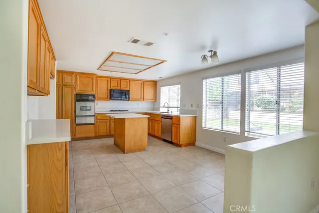 a large kitchen with lot of cabinets and a sink