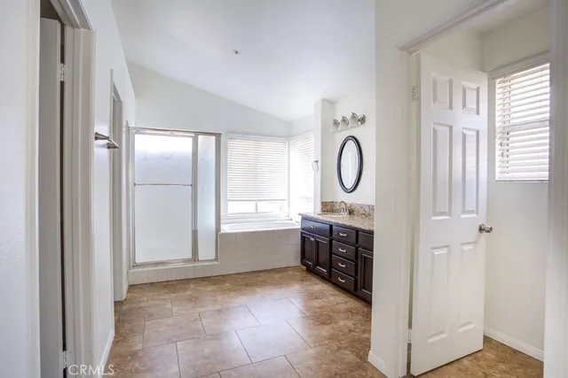 a large bathroom with a sink a mirror and a bathtub