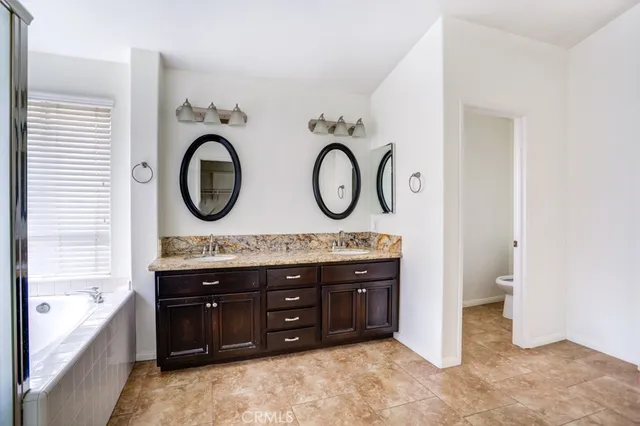a bathroom with a double vanity sink and a bathtub
