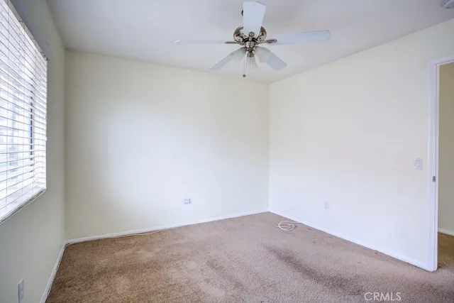 a view of a big room with a chandelier fan