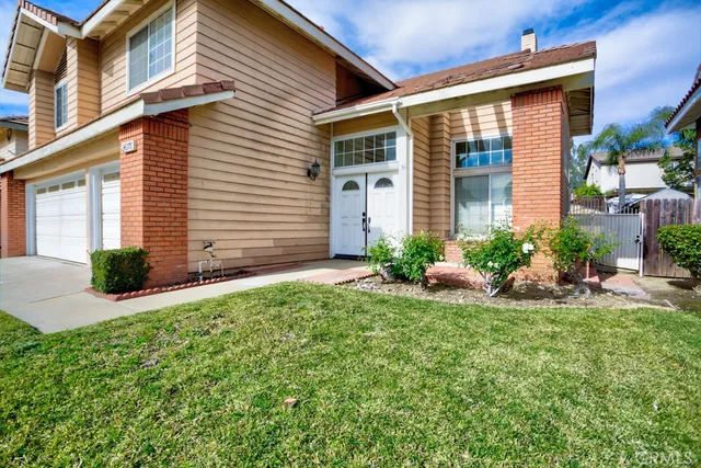 a front view of a house with a yard and porch