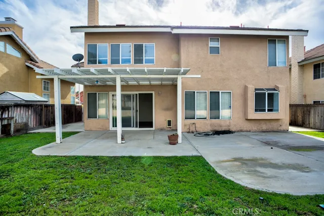 a view of a house with a yard and sitting area