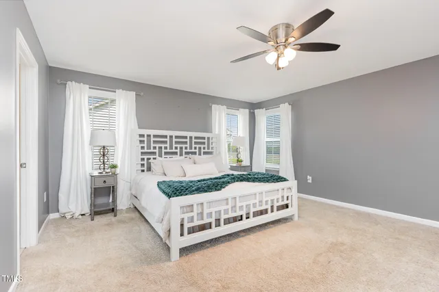 a bed sitting in a room next to a window