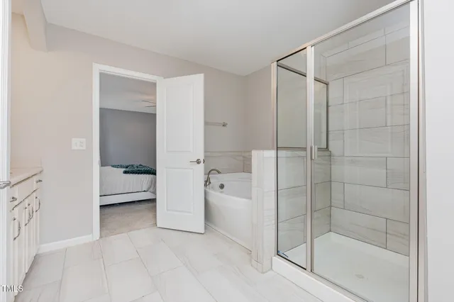 a bathroom with a bathtub and a shower