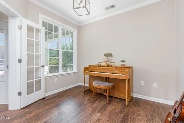 a room with chair table and wooden floor