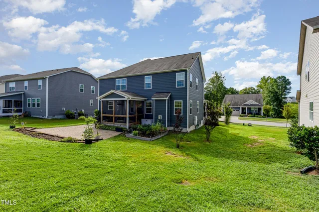 a view of a house with a big yard and a large tree