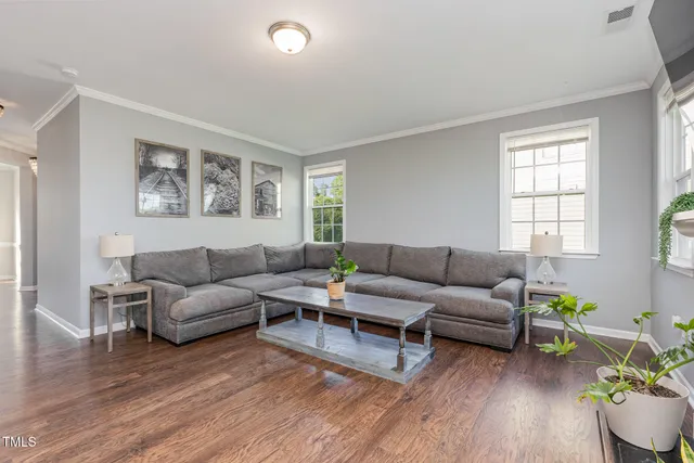 a living room with furniture and wooden floor