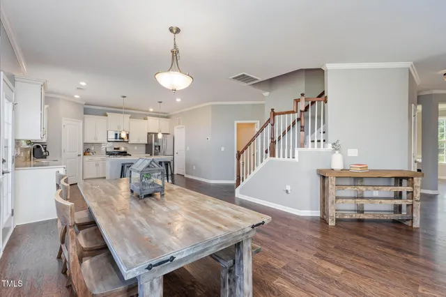 a view of a dining room with furniture and wooden floor