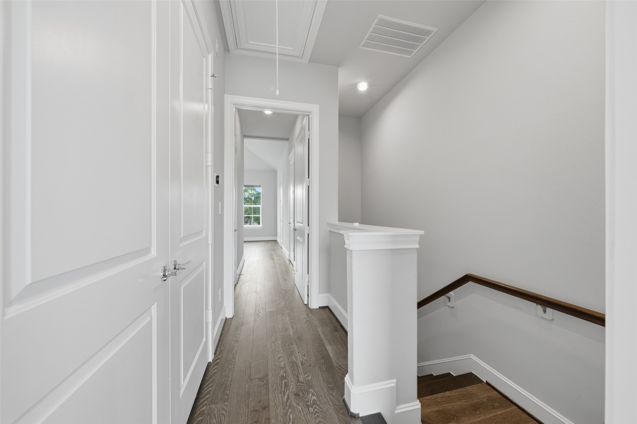 8612 Emnora Lane Houston, TX 77080 - Photo 23 of 45 a view of a hallway with wooden floor and staircase