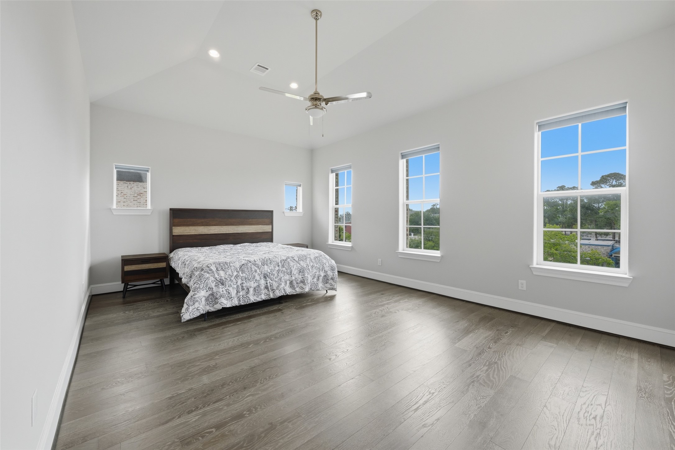 8612 Emnora Lane Houston, TX 77080 - Photo 24 of 45 a bedroom with a large bed chandelier and a window