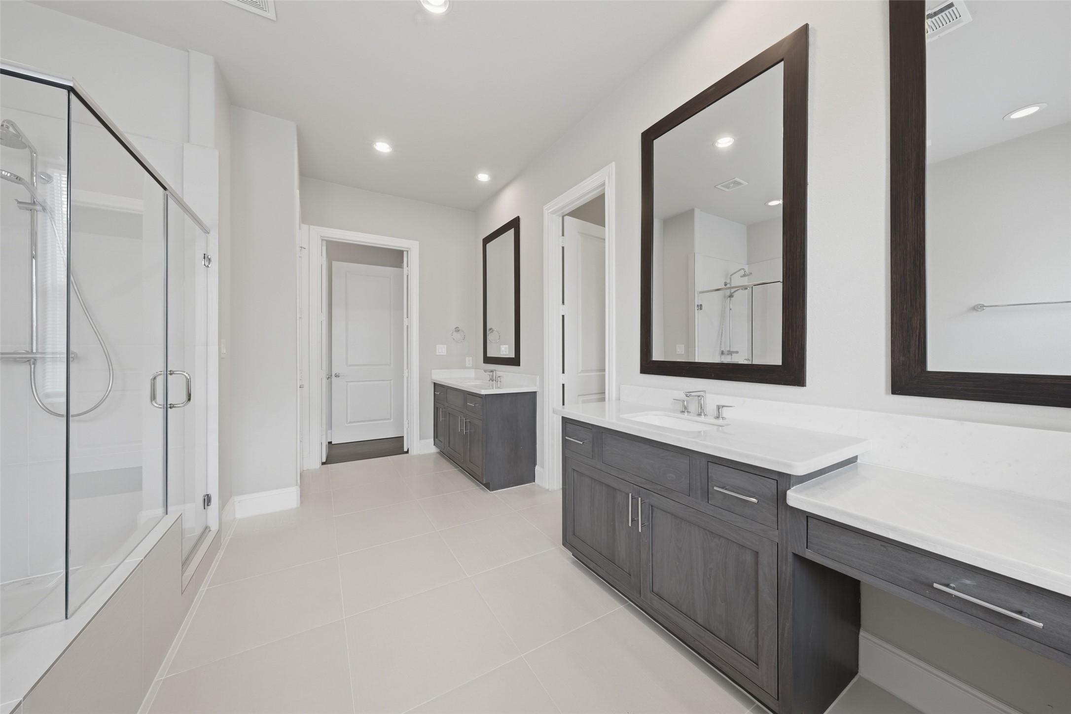 8612 Emnora Lane Houston, TX 77080 - Photo 29 of 45 a bathroom with a double vanity sink a mirror and a bathtub